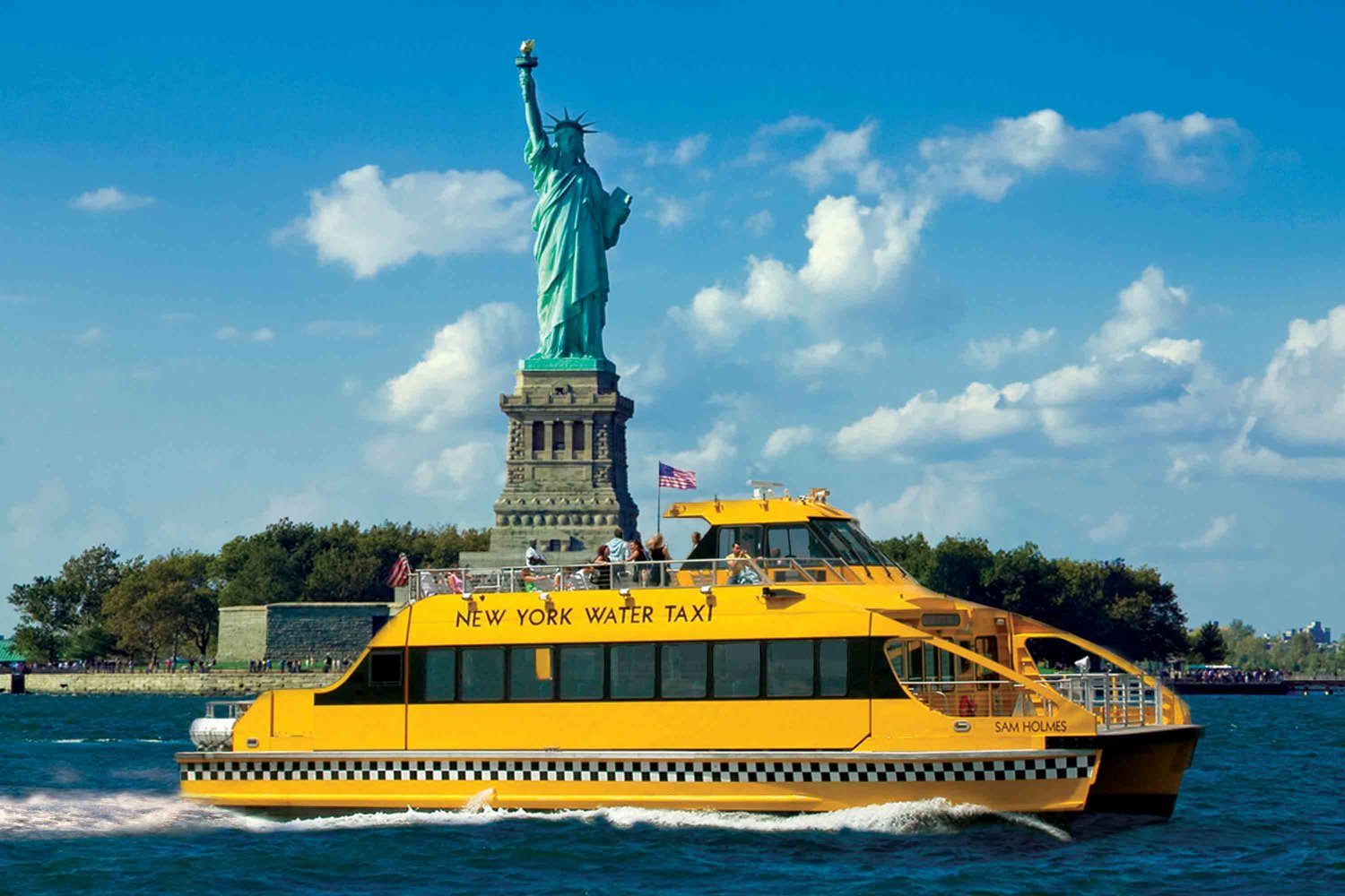 New York Water Taxi in front of the Statue of Liberty.